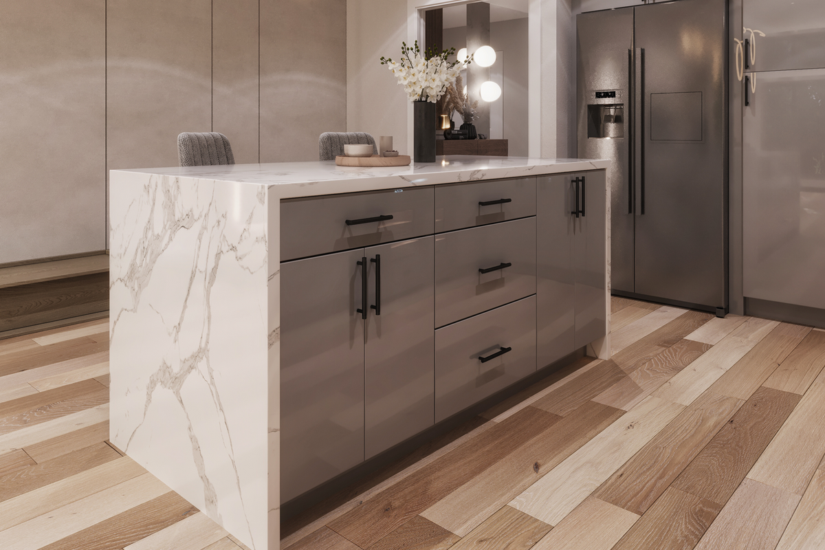 A modern kitchen island with a white marble-patterned side panel and a white countertop, paired with glossy gray cabinets and black handles. The island is set in a contemporary kitchen with light wood floors, stainless steel appliances, and a vase of flowers on top.